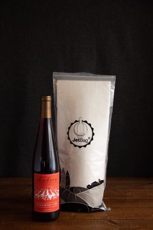 
                  
                    Load image into Gallery viewer, A JetBag used to protect your wine while traveling sitting behind a bottle of Aubrey Vineyards Frontenac Rosé.
                  
                