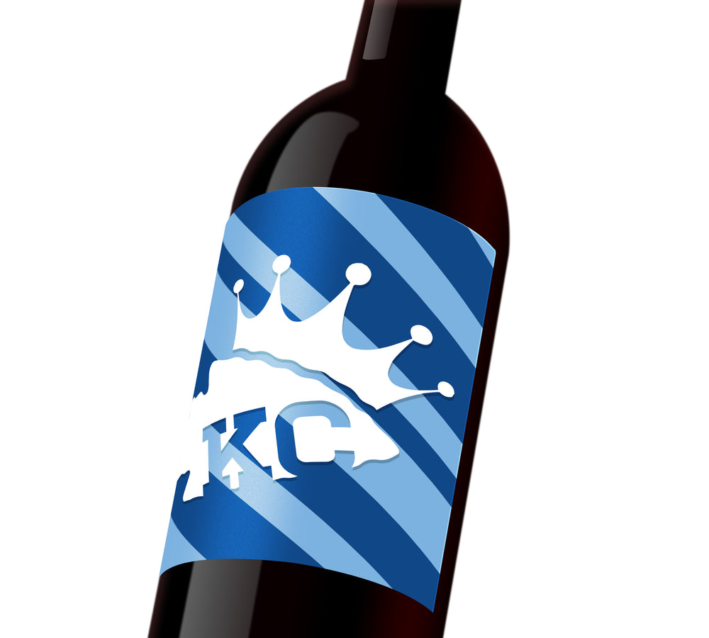 A dark and light blue striped custom wine label with a white Chiefs spearhead that reads, 