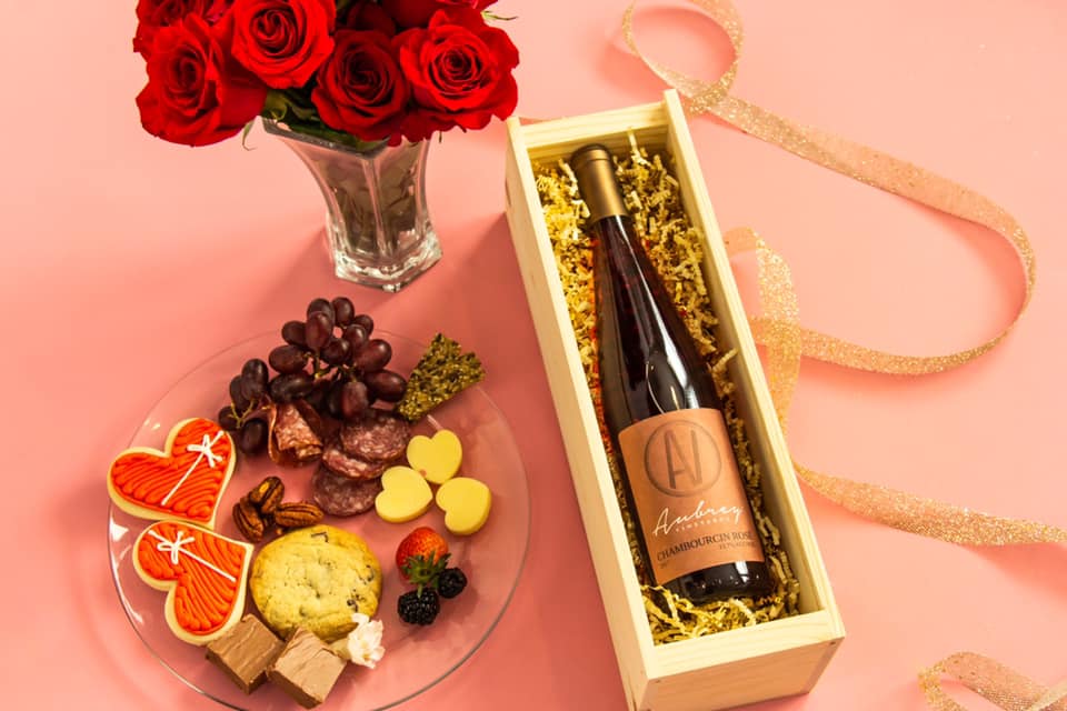 Valentine's Day Gift Box. Chambourcin Rose in wooden wine box, red roses, and treats.