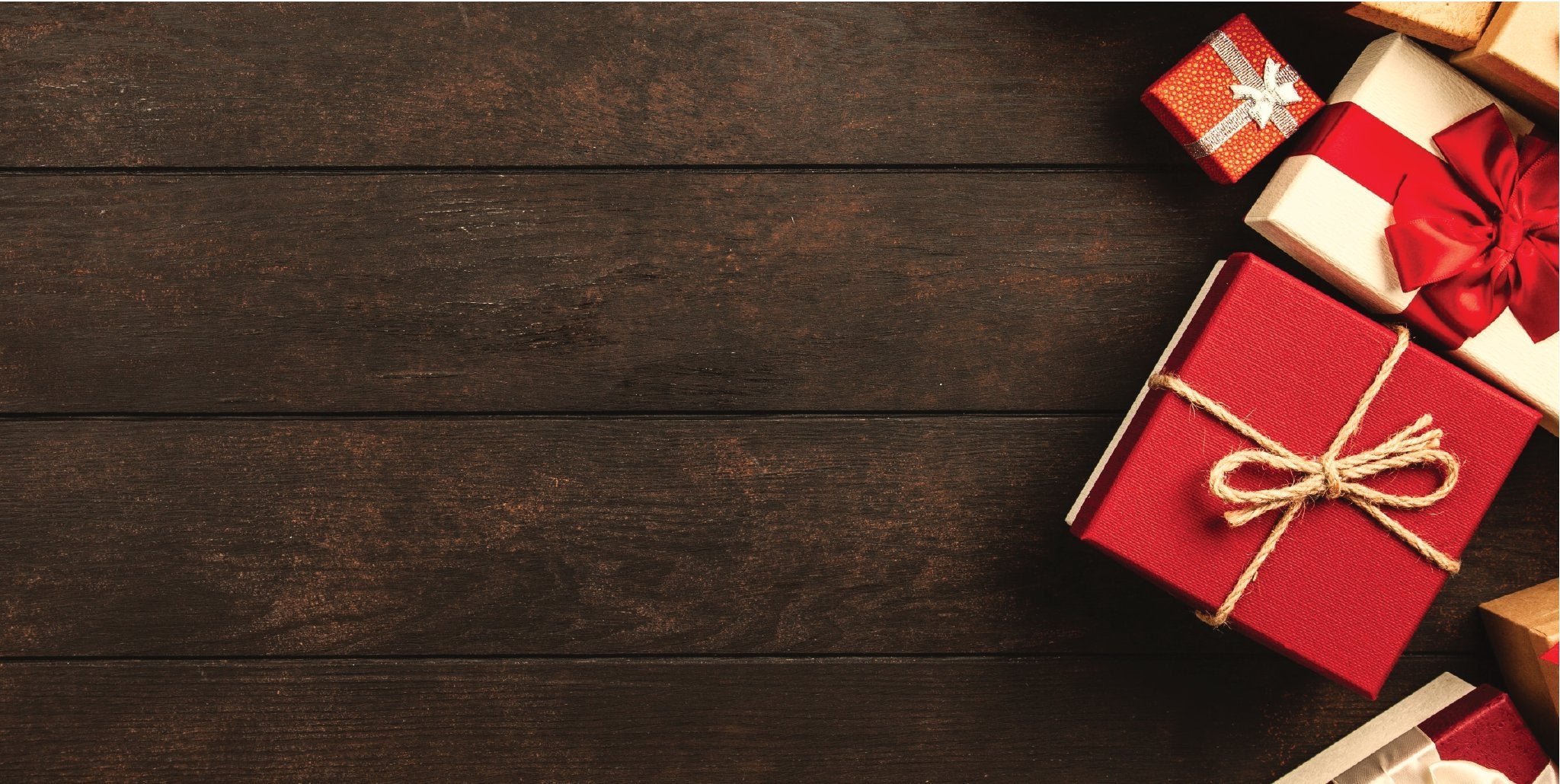Maroon gift boxes on a dark wood table