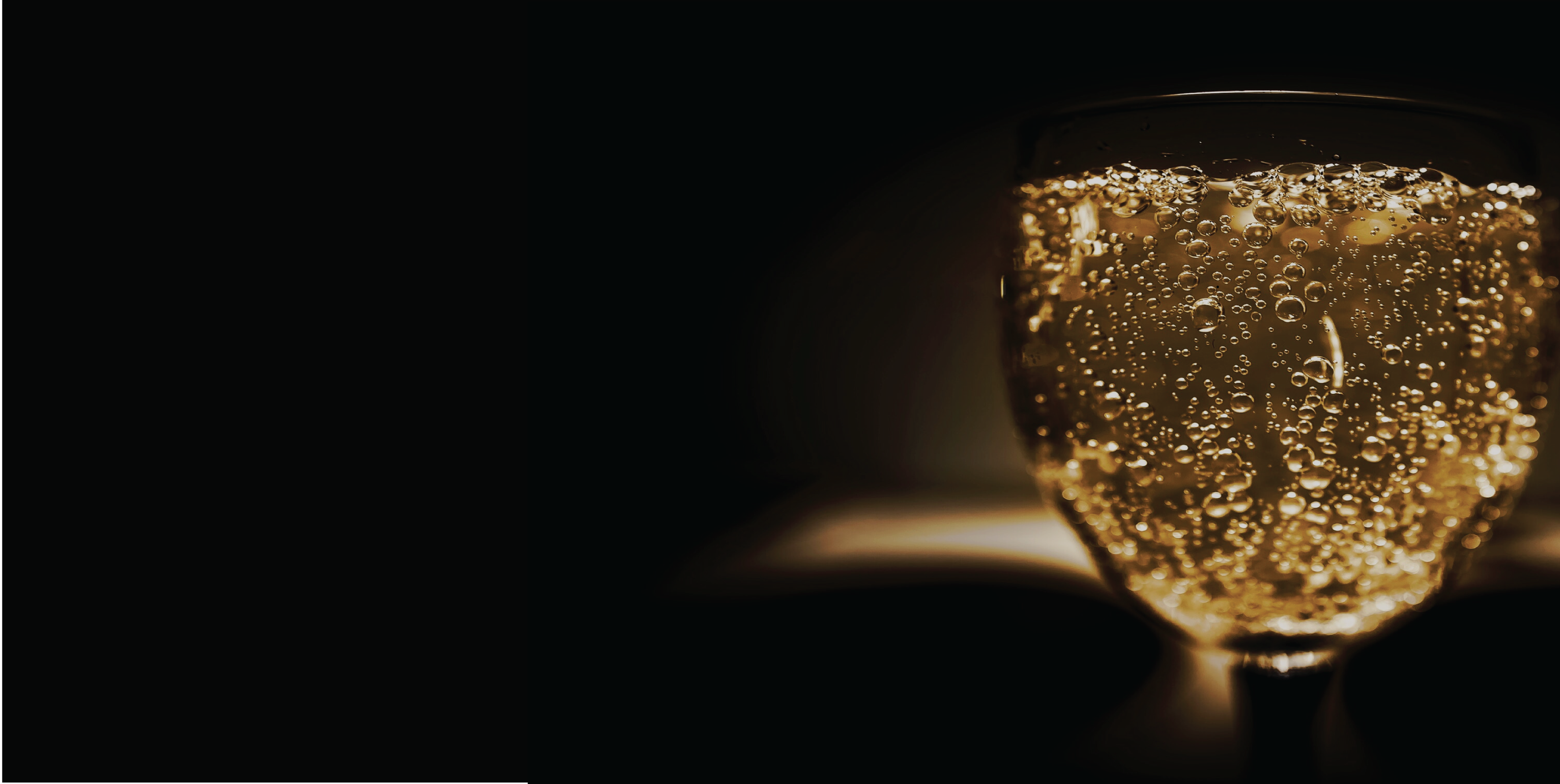 Spritzed wine pictured against a black background.