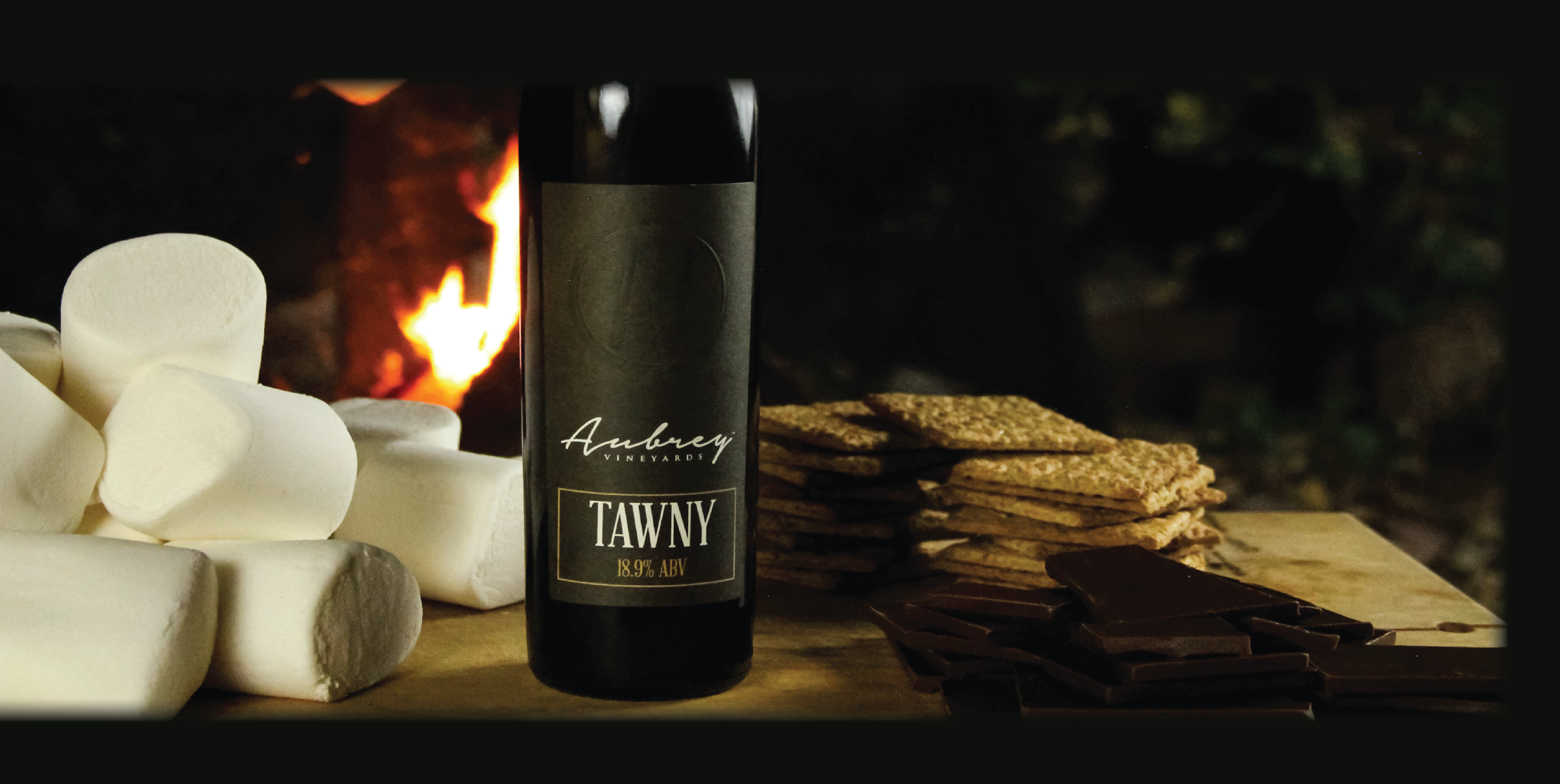 Tawny pictured with s'mores ingredients near a fire.