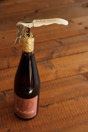 
                  
                    Load image into Gallery viewer, A white Aubrey Vineyards corkscrew positioned in the cork of a 2017 Chambourcin Rosé.
                  
                