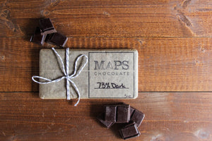 
                  
                    Load image into Gallery viewer, Maps 73% Dark Chocolate Bar on a wooden table. 
                  
                