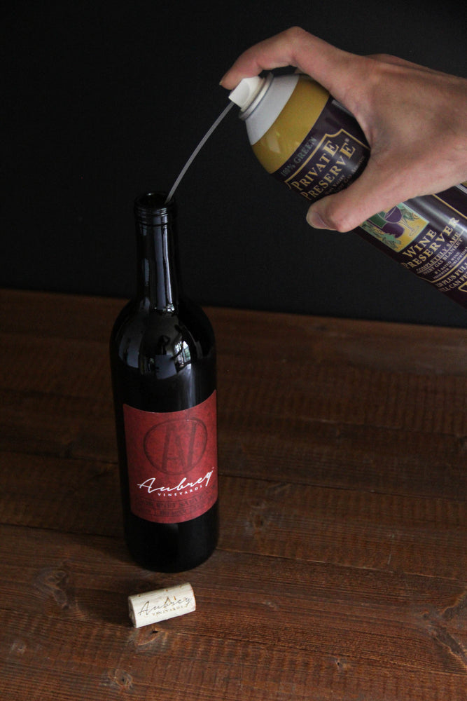
                  
                    Load image into Gallery viewer, A can of Private Preserve being used to preserve an open bottle of Aubrey Vineyards Crimson Cabernet.
                  
                