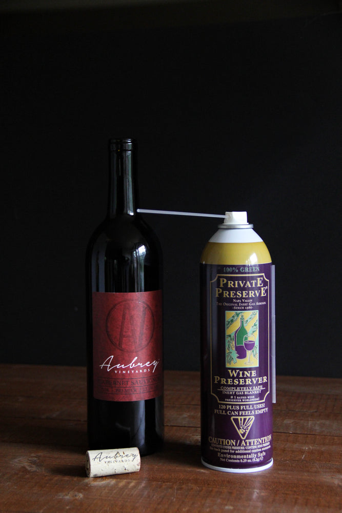 
                  
                    Load image into Gallery viewer, A can of Private Preserve sitting next to a bottle of Aubrey Vineyards Crimson Cabernet.
                  
                