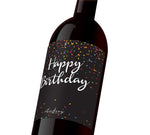 A black custom wine label with colorful confetti that reads, "Happy Birthday".