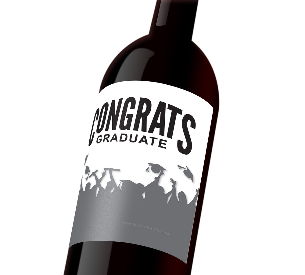 A white wine label with silhouetted students tossing their graduation caps. The label reads, "Congrats Graduate".