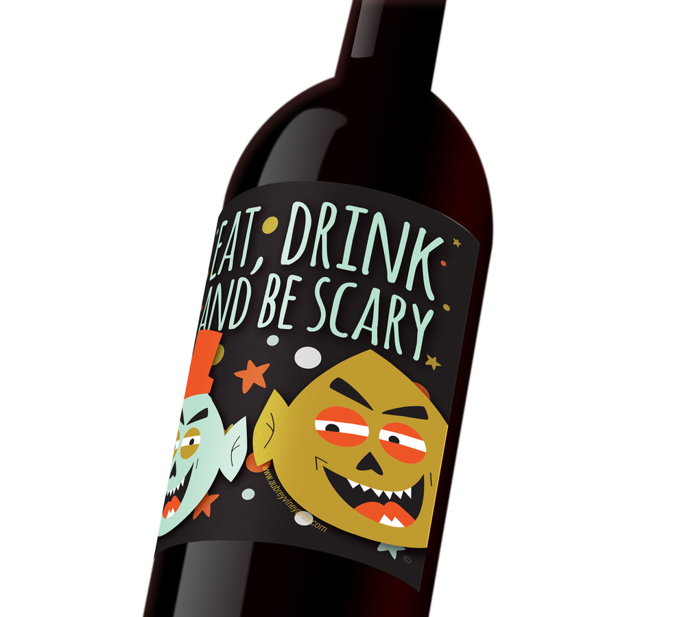 A Halloween wine labels depicting two cartoon-like monster faces that reads, "Eat, drink, and be scary."