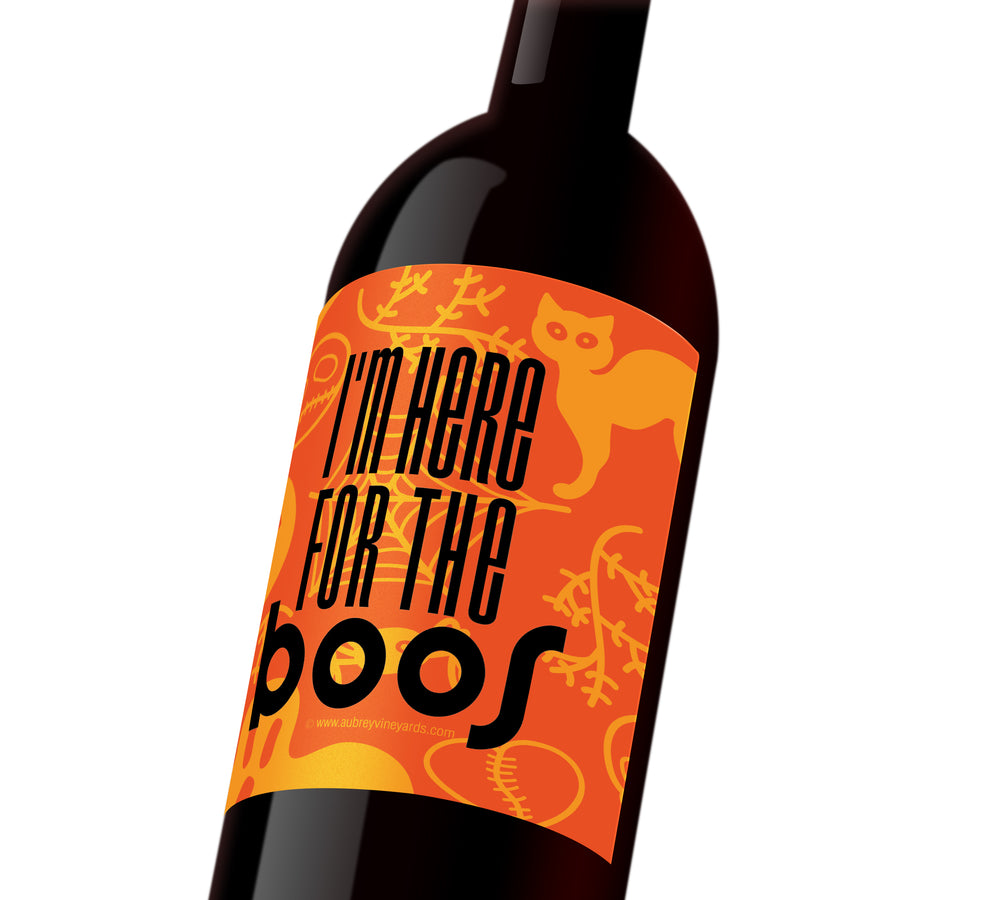 An orange Halloween wine label with cats, ghosts, and spiderwebs that reads, 