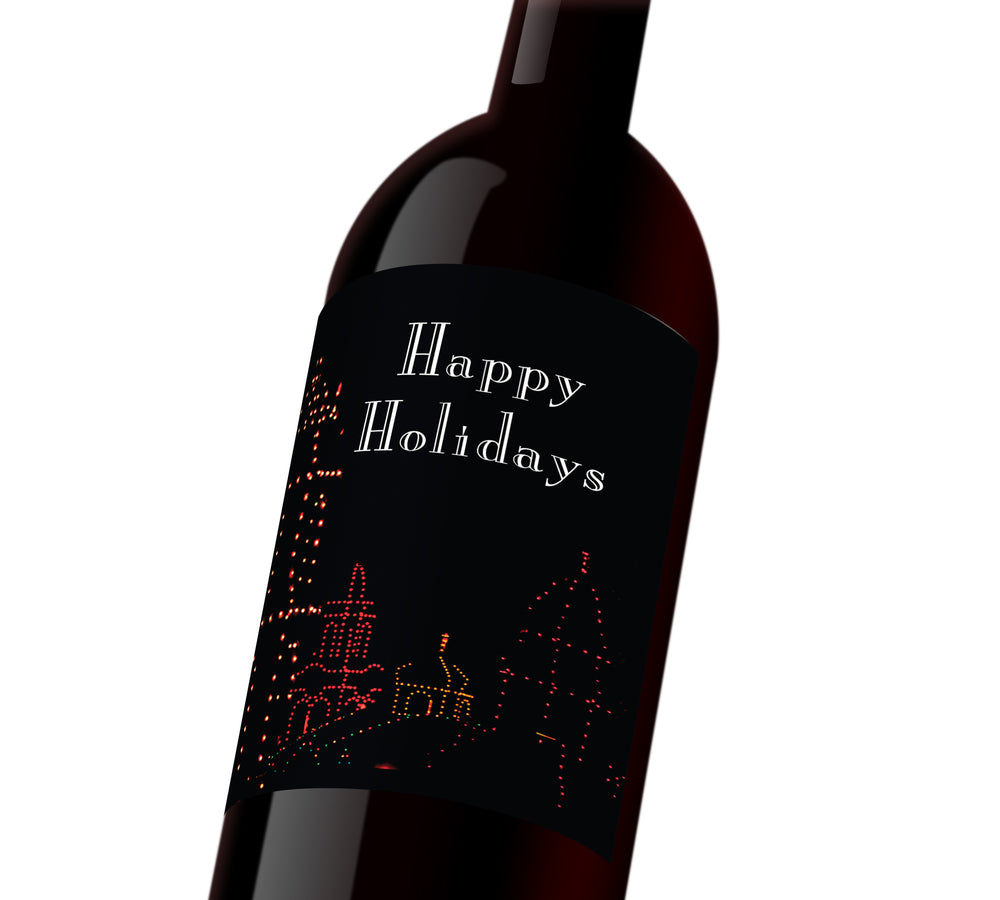 A black holiday custom wine label with the plaza outlined in holiday lights. The label reads, 