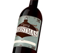 Blue custom wine label with a brown holiday ornament that reads, "Merry Christmas" with a "to" and "from" banner at the bottom.