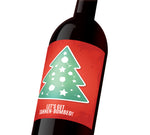 A red holiday custom wine label with a green tree decorated with stars and wine glasses. The label reads, "Let's get Tannen-bombed!"